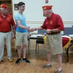 
Dakota Hemberger being presented with Scholarship by Commandant Joe Johnston.  Father Dennis Hemberger looking on